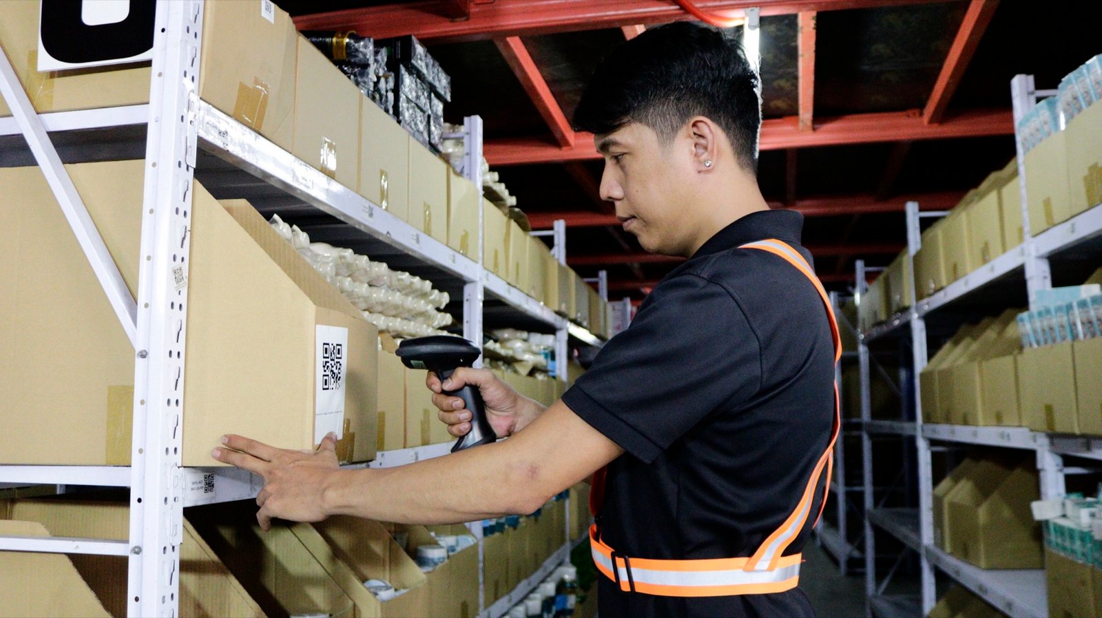 Warehouse operator scanning stock on the shelf